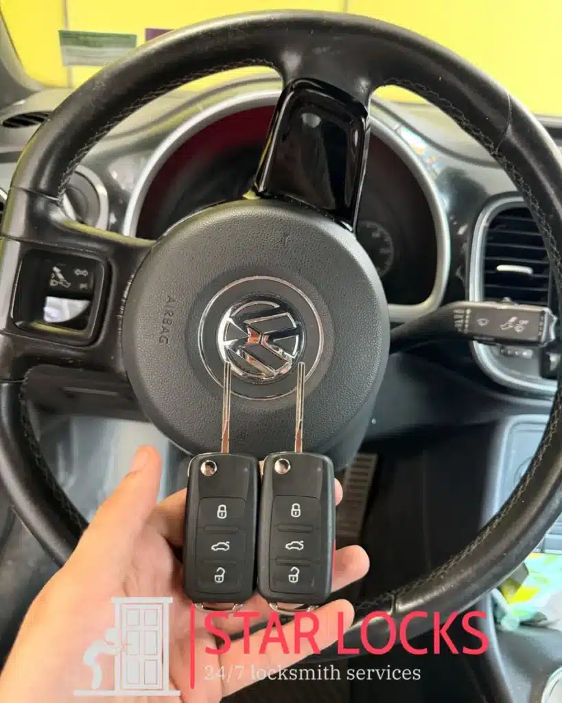 Star Locks mobile locksmith holding duplicate car keys for car key duplication service in Waltham MA